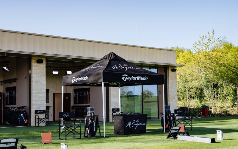 a taylormade branded gazeebo outside the golf studio at the grove in front of slim external sliding doors
